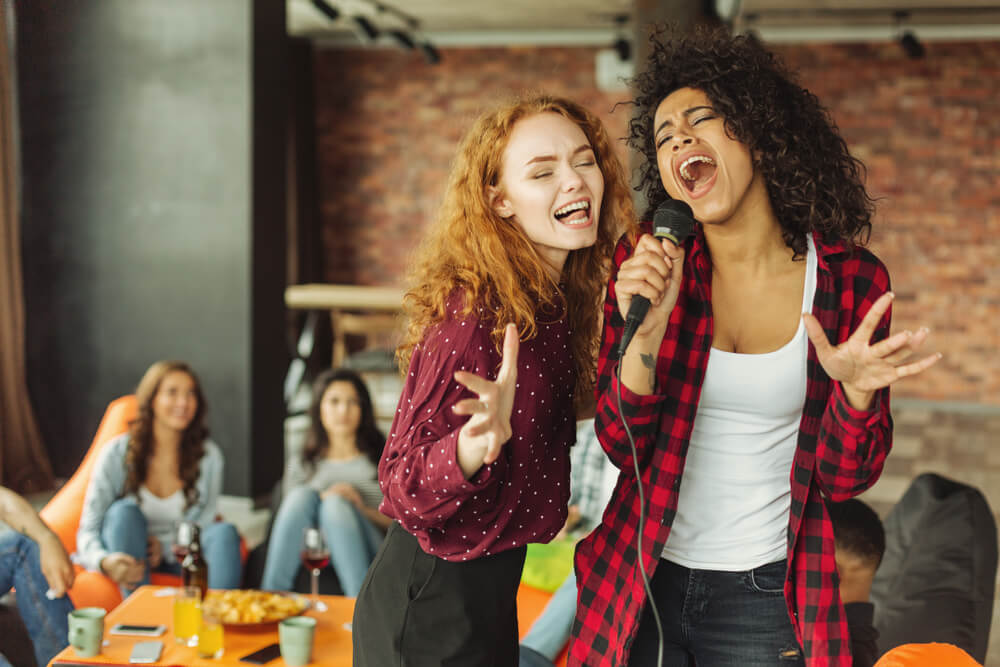 Happy Friends Singing Together At Home. Karaoke Party Concept