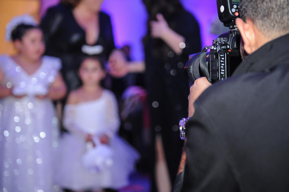 The photographer holds the camera towards a group of people.