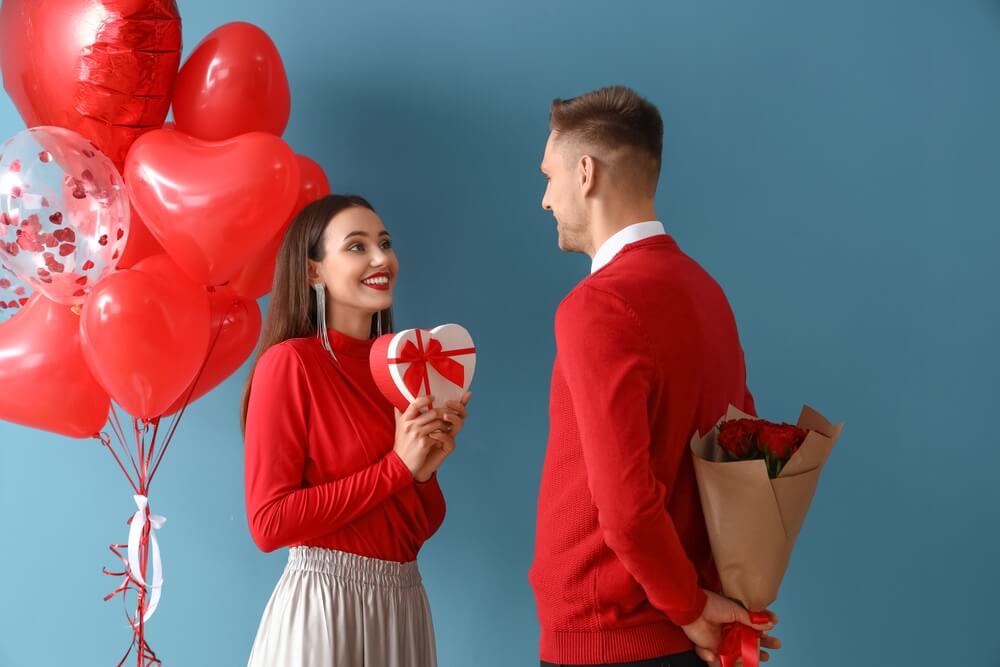 Young man greeting his girlfriend for Valentine's Day.